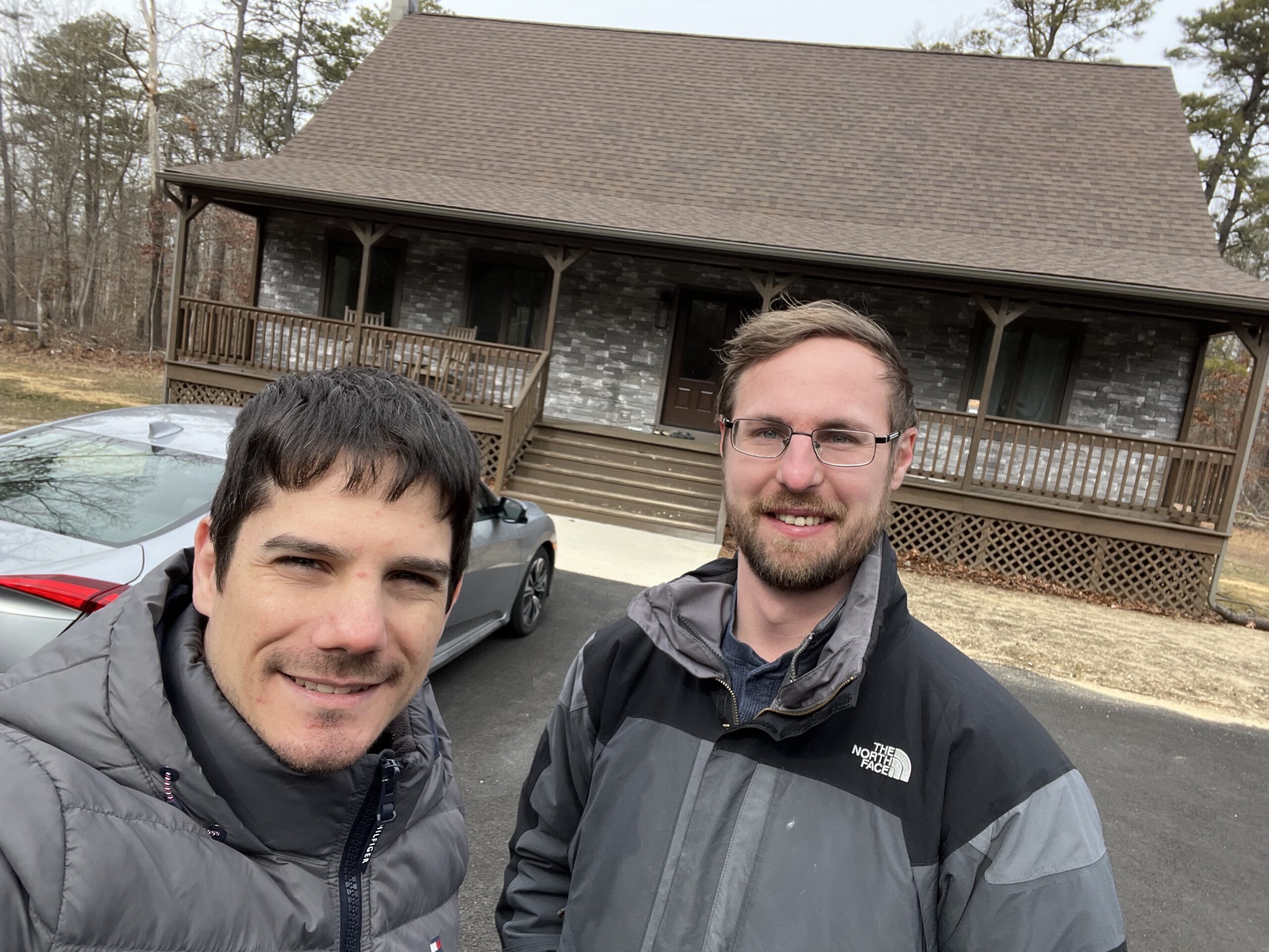 Medford homeowner standing in front of new ecc roof replacement